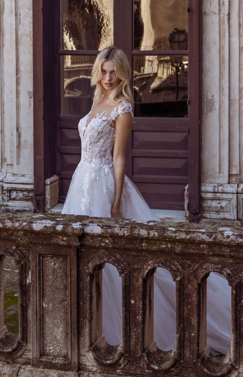 Photo of the model wearing a white bridal gown near the door